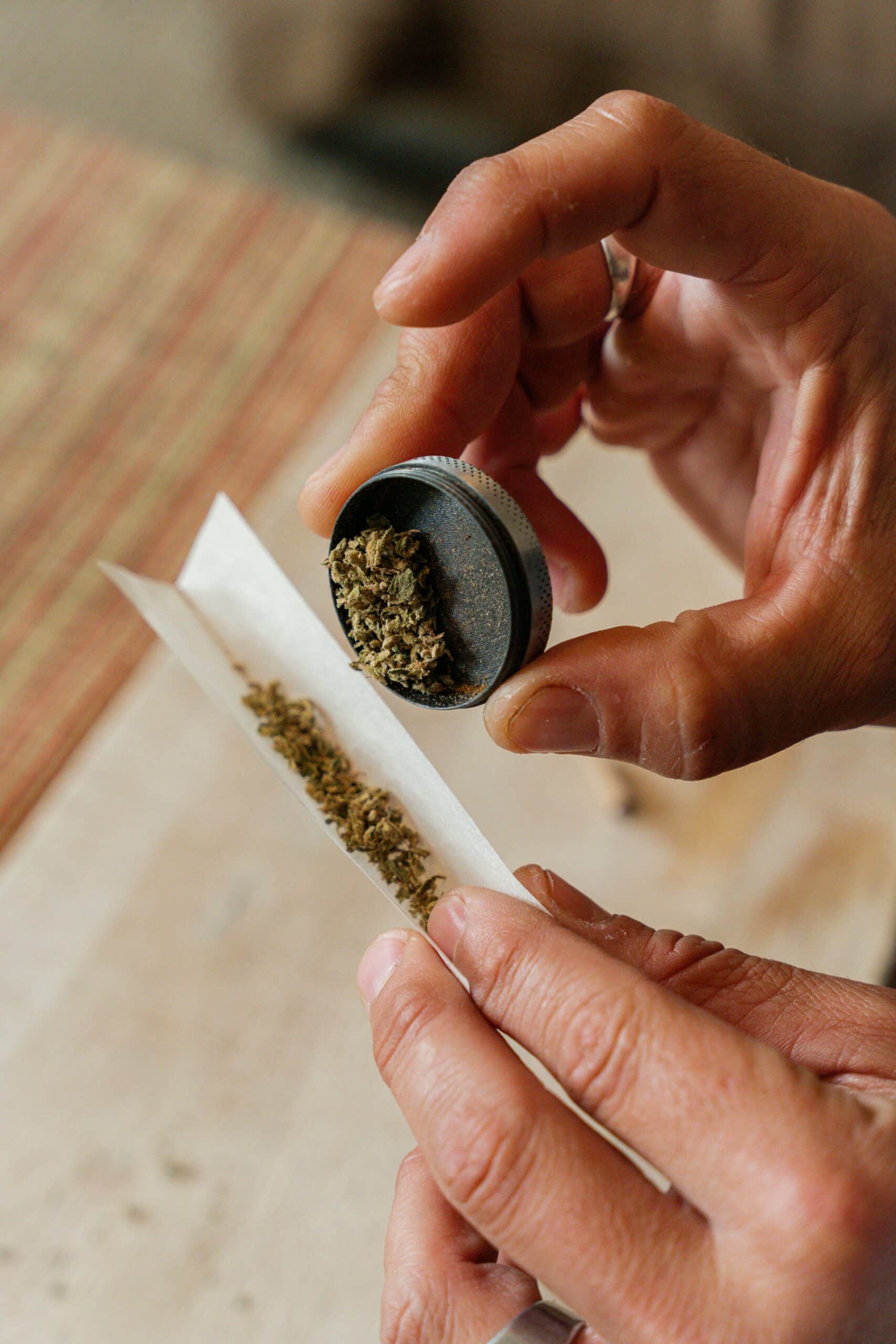 person packing cannabis joint