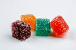 Vibrant colored marijuana gummy candies set on a white background